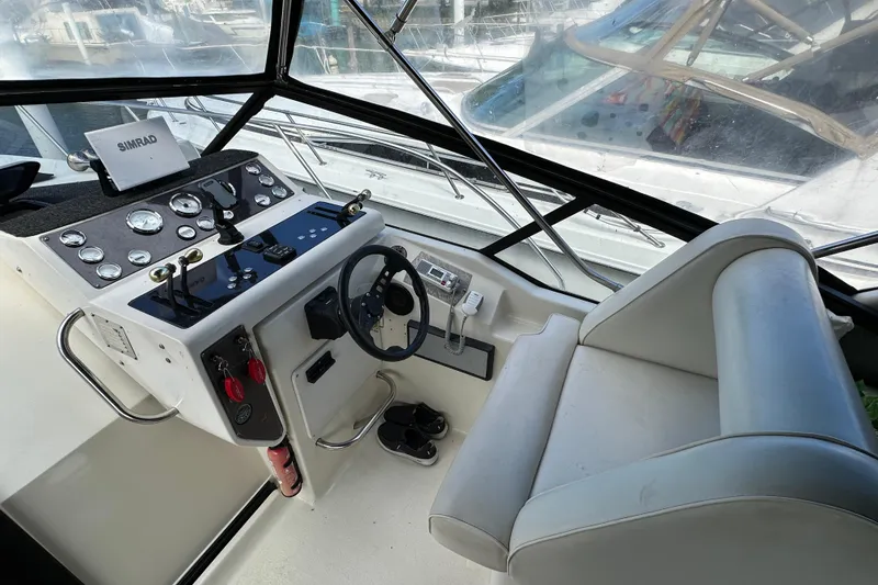 Slide: The Image of 1990 Silverton 34 Express boat helm with steering wheel and control panel. - 16