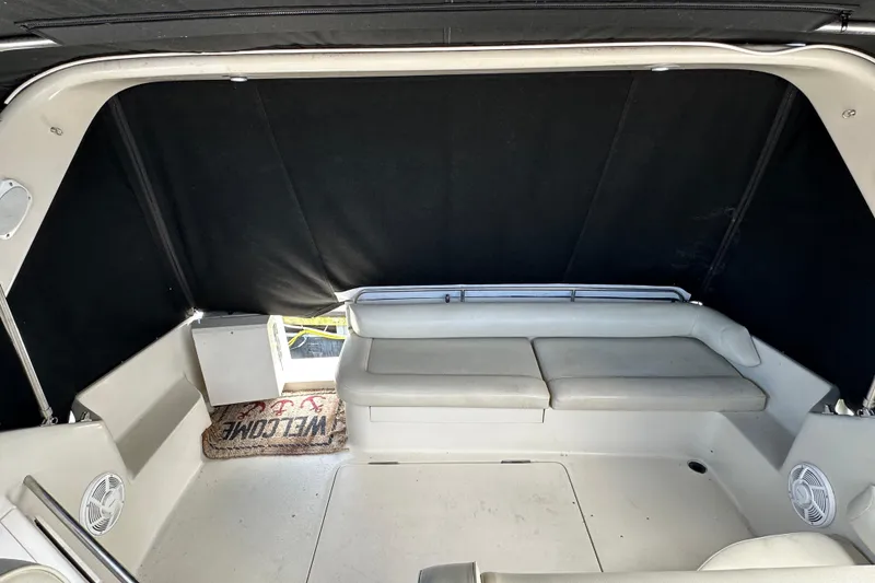 Slide: The Image of 1990 Silverton 34 Express boat interior with seating and welcome mat. - 18