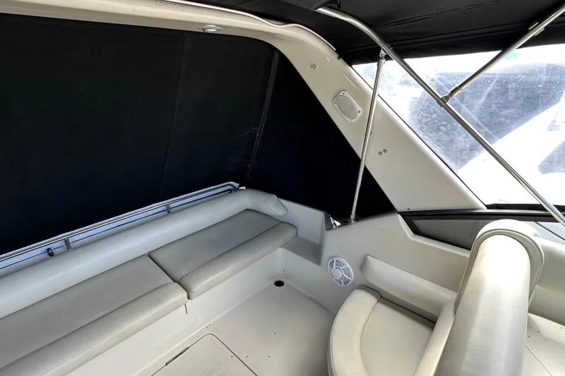 Slide: The Image of Interior of 1990 Silverton 34 Express boat with cushioned seating and black canopy. - 19