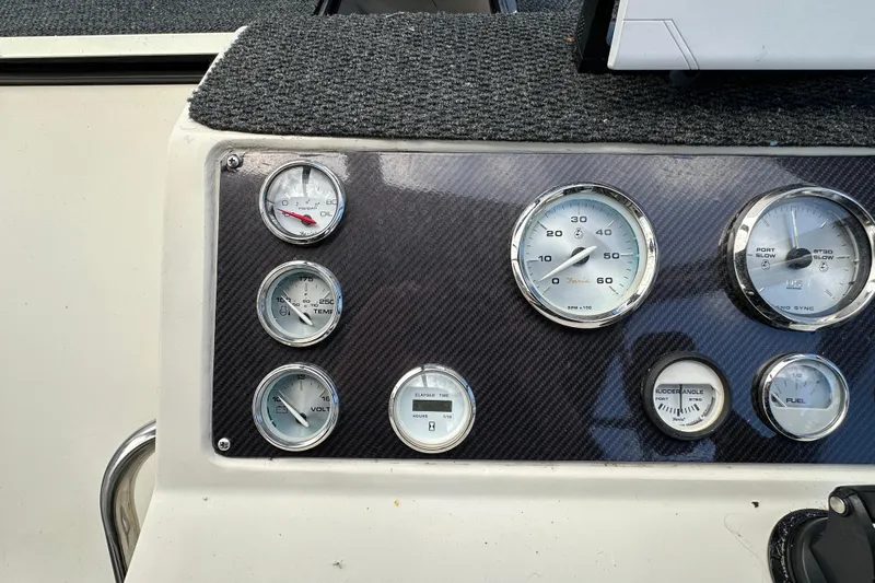 Slide: The Image of Dashboard of a 1990 Silverton 34 Express boat with various gauges and instruments. - 24