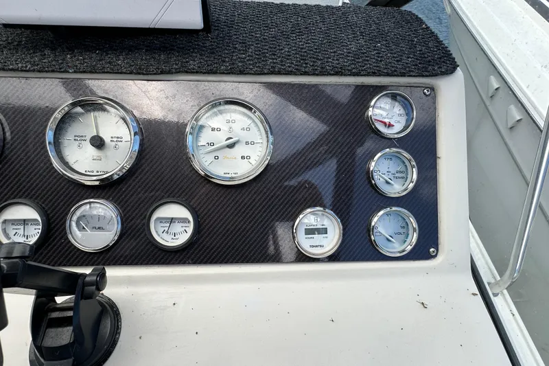 Slide: The Image of Dashboard of a 1990 Silverton 34 Express boat with various gauges and controls. - 25