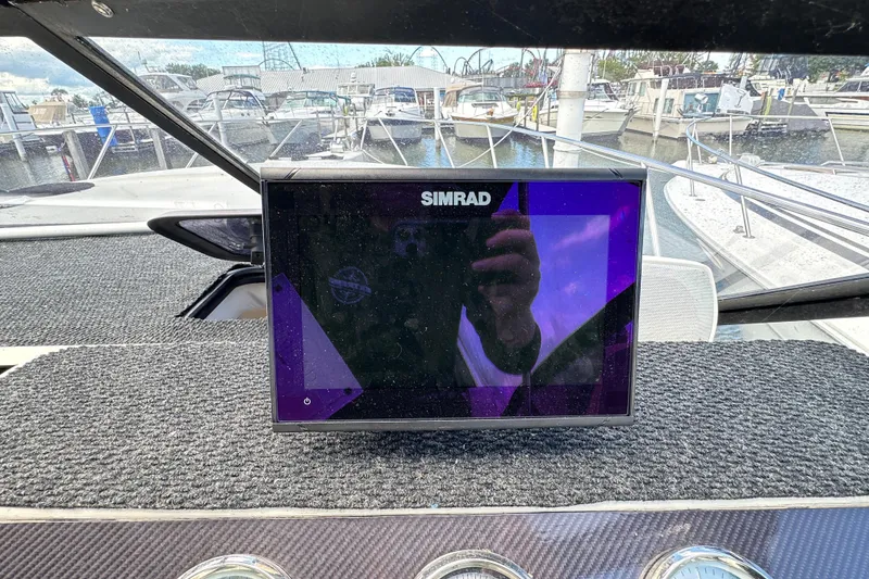 Slide: The Image of Simrad display on 1990 Silverton 34 Express boat dashboard at marina. - 26