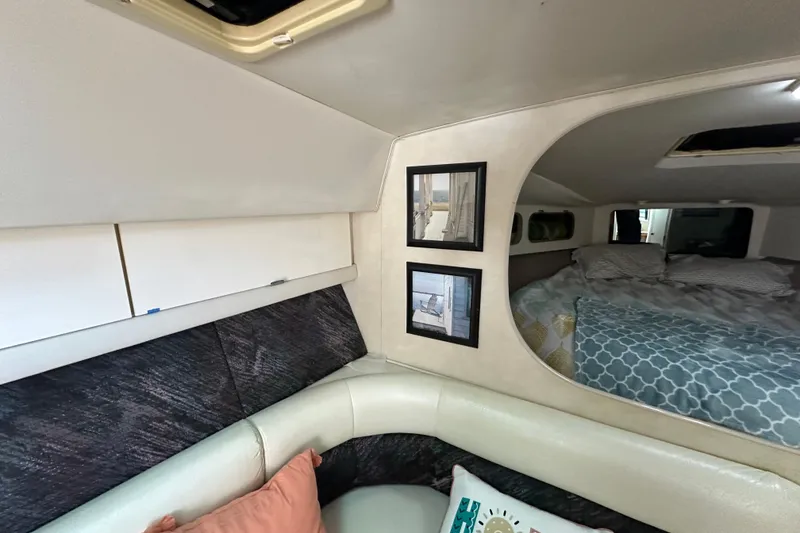 Slide: The Image of Interior of 1990 Silverton 34 Express boat with cozy seating and framed pictures. - 36