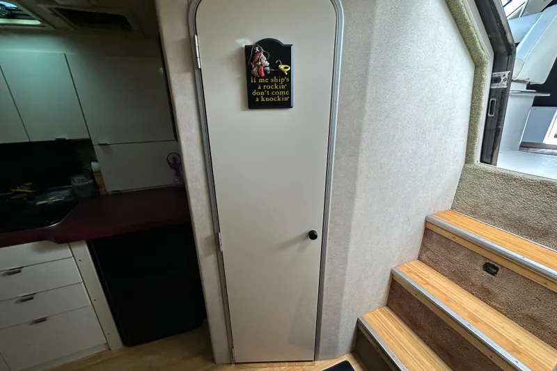 Slide: The Image of Interior of 1990 Silverton 34 Express boat with stairs and cabin door. - 40