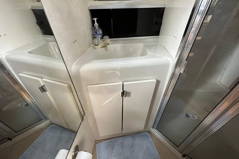 Slide: The Image of 1990 Silverton 34 Express bathroom with sink, mirror, and shower. - 42