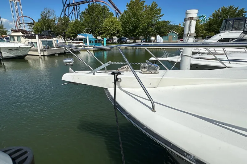Slide: The Image of 1990 Silverton 34 Express docked at marina, with roller coaster in background. - 7