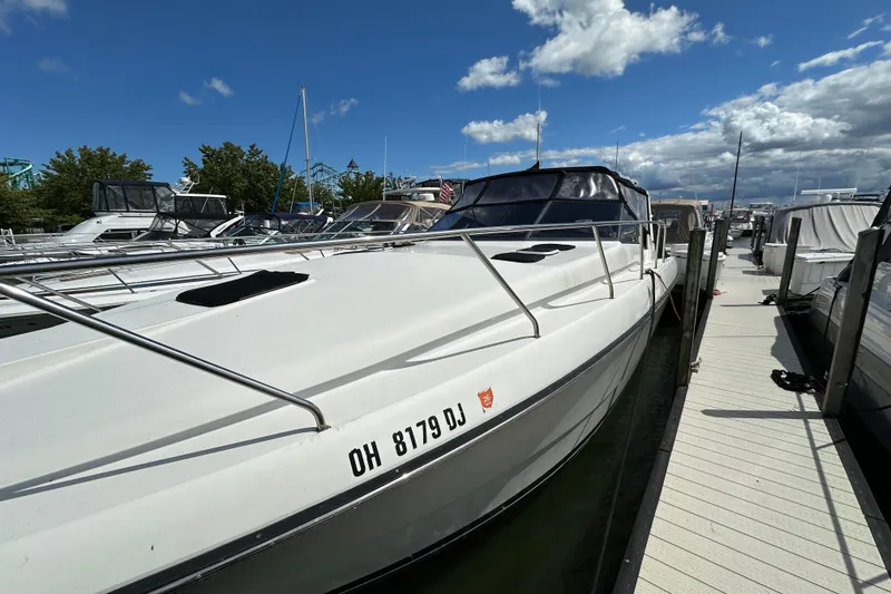 Slide: The Image of 1990 Silverton 34 Express boat docked at marina under blue sky. - 8