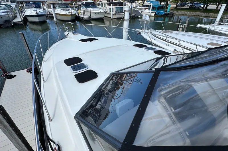 Slide: The Image of 1990 Silverton 34 Express boat docked at marina with other vessels. - 9