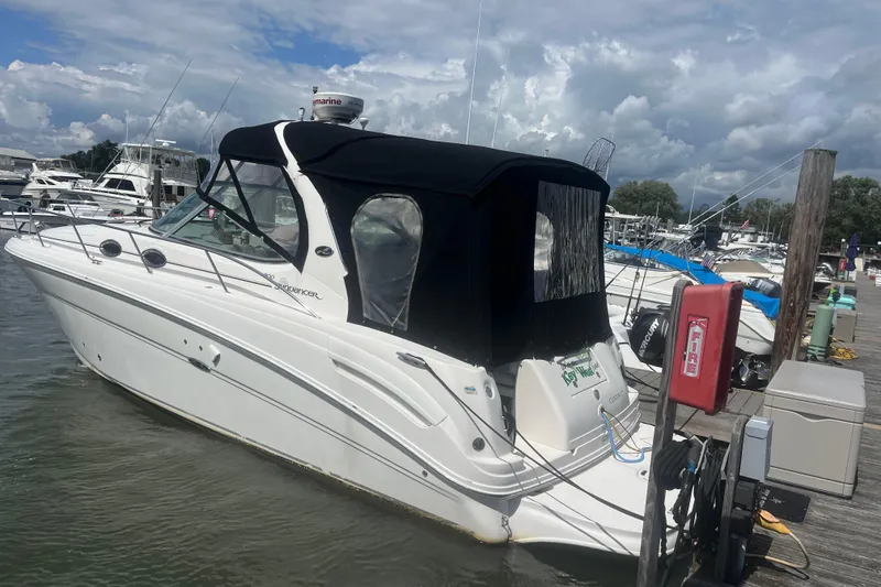 The Image of 2007 Sea Ray 300 Sundancer docked at marina under cloudy sky. - 0