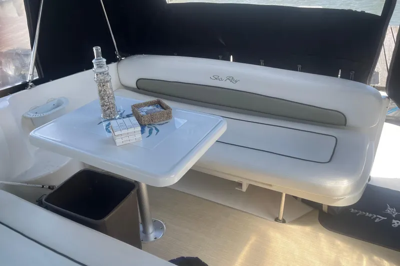 Slide: The Image of 2007 Sea Ray 300 Sundancer interior with seating and table setup. - 11
