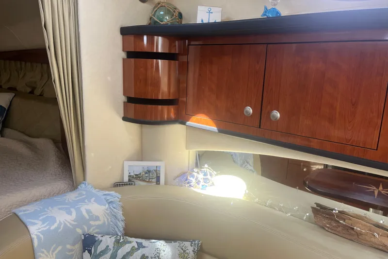 Slide: The Image of Interior of 2007 Sea Ray 300 Sundancer with wooden cabinets and nautical decor. - 15