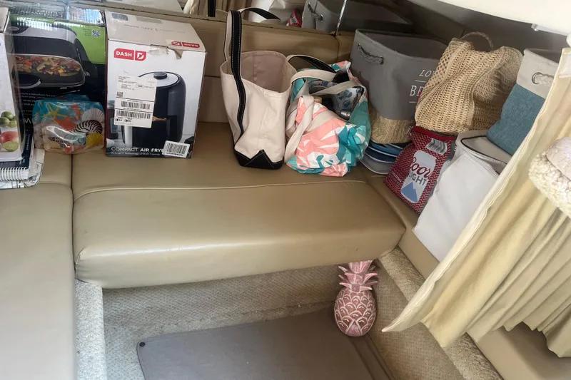 Slide: The Image of Interior of a 2007 Sea Ray 300 Sundancer with various bags and a compact air fryer. - 16