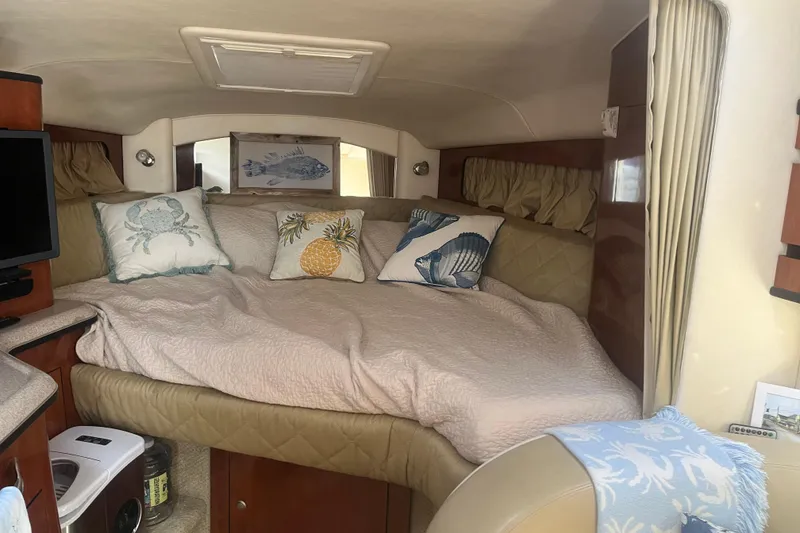 Slide: The Image of Cozy interior of 2007 Sea Ray 300 Sundancer with decorative pillows and bedding. - 17