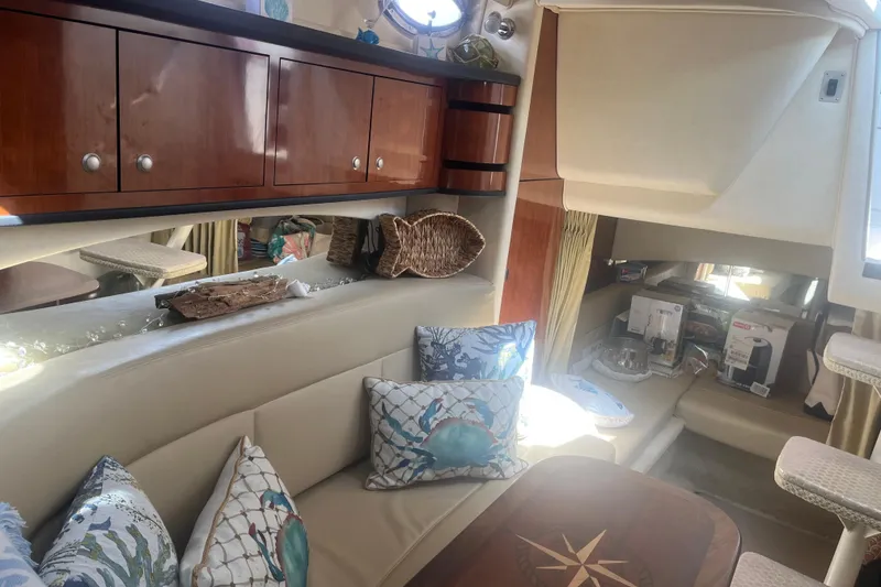 Slide: The Image of Interior of 2007 Sea Ray 300 Sundancer with cozy seating and nautical decor. - 22