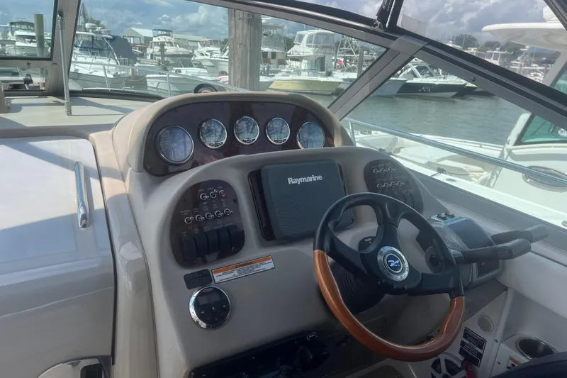 Slide: The Image of Cockpit of 2007 Sea Ray 300 Sundancer with steering wheel and instrument panel. - 25