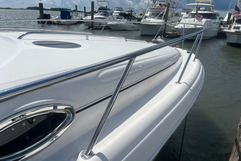 Slide: The Image of 2007 Sea Ray 300 Sundancer docked, showcasing sleek white hull and stainless steel railings. - 4