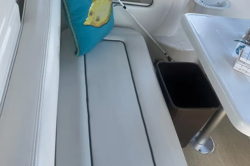 Slide: The Image of Interior of 2007 Sea Ray 300 Sundancer with cushioned seating and decorative pillow. - 8