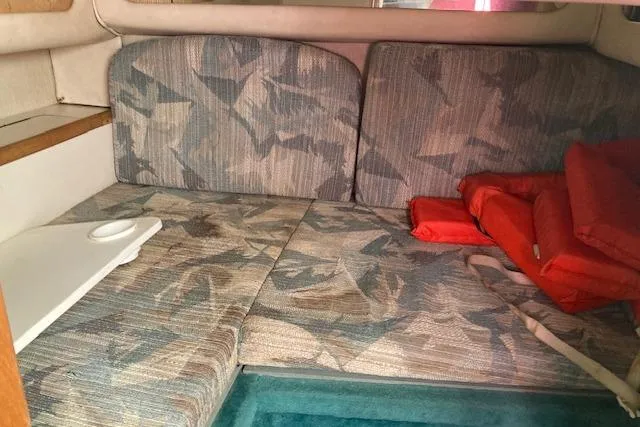 Slide: The Image of Interior cabin of 1994 Sea Ray 290 Sundancer with patterned seating and life jackets. - 7