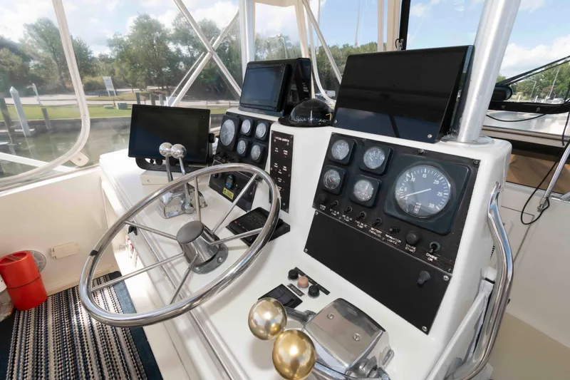 Slide: The Image of Cockpit of 1990 Viking 50 Motor Yacht with steering wheel and navigation instruments. - 10