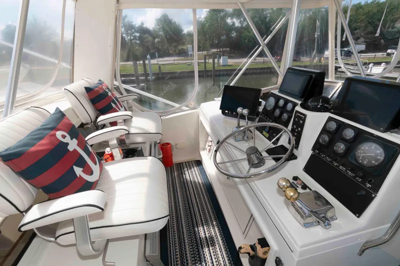 Slide: The Image of Interior of 1990 Viking 50 Motor Yacht helm with nautical decor and control panels. - 11
