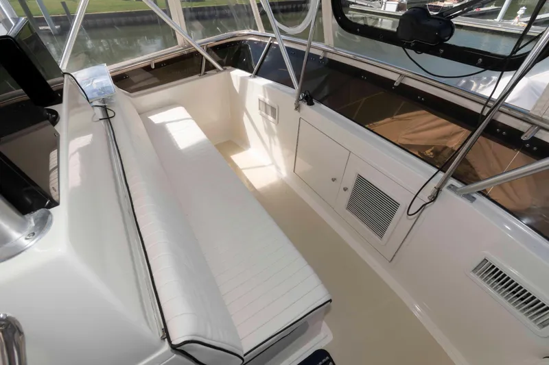 Slide: The Image of Interior view of 1990 Viking 50 Motor Yacht with white seating and windows. - 13