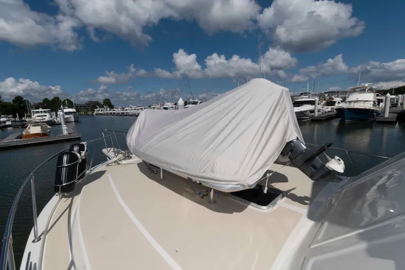Slide: The Image of 1990 Viking 50 Motor Yacht docked at marina under cloudy sky. - 15