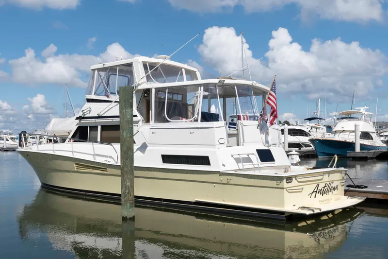 Slide: The Image of 1990 Viking 50 Motor Yacht docked at marina under blue sky. - 2