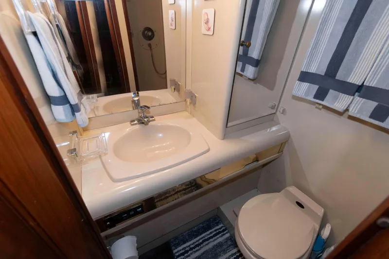 Slide: The Image of Bathroom interior of 1990 Viking 50 Motor Yacht with sink, mirror, and toilet. - 29