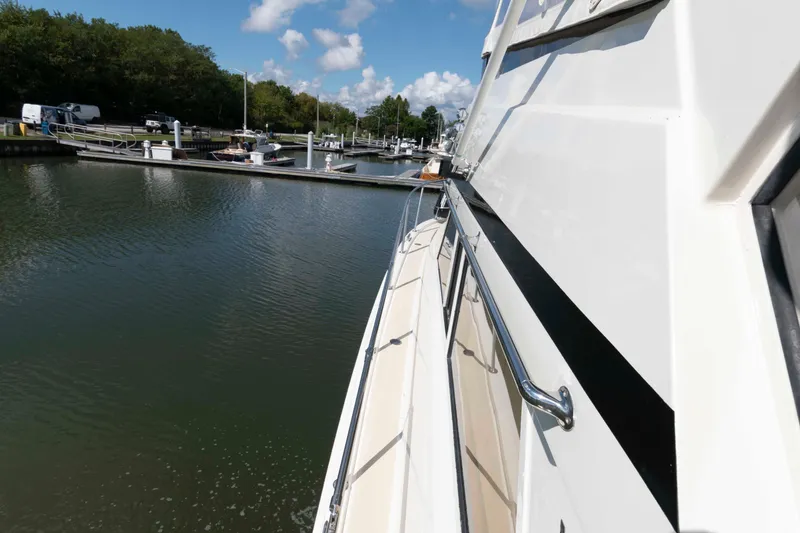 Slide: The Image of 1990 Viking 50 Motor Yacht docked at a marina under a clear blue sky. - 3