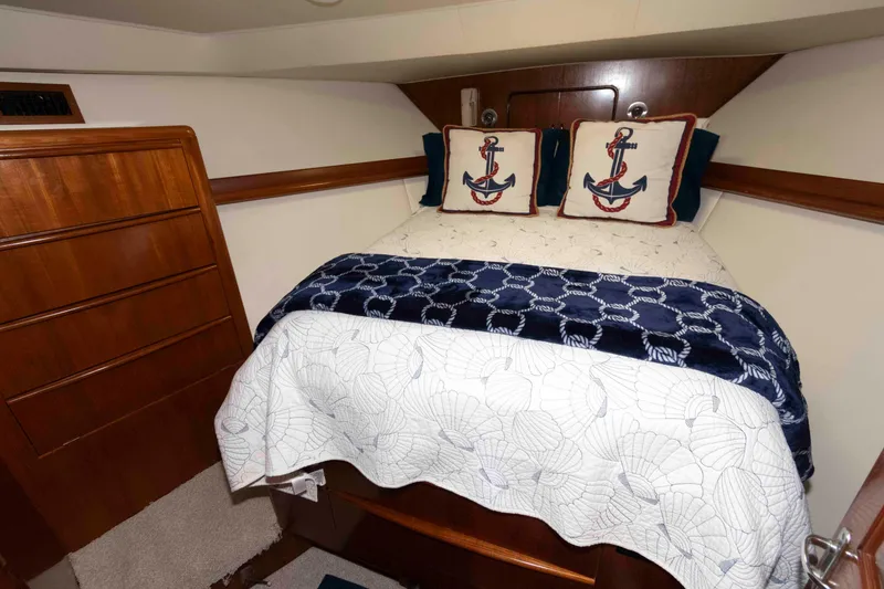 Slide: The Image of Cozy bedroom in 1990 Viking 50 Motor Yacht with nautical-themed decor. - 31