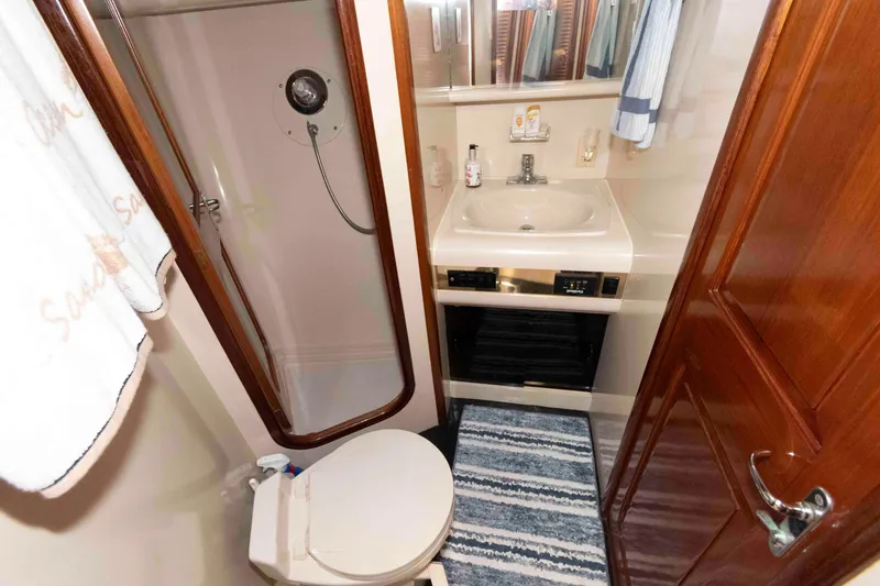 Slide: The Image of Bathroom interior of 1990 Viking 50 Motor Yacht with shower, sink, and toilet. - 32