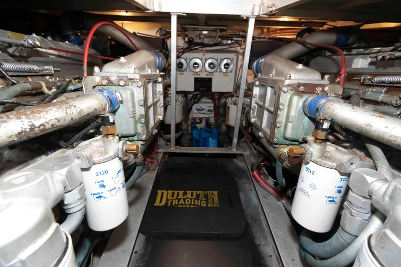 Slide: The Image of Engine room of 1990 Viking 50 Motor Yacht with visible machinery and filters. - 33