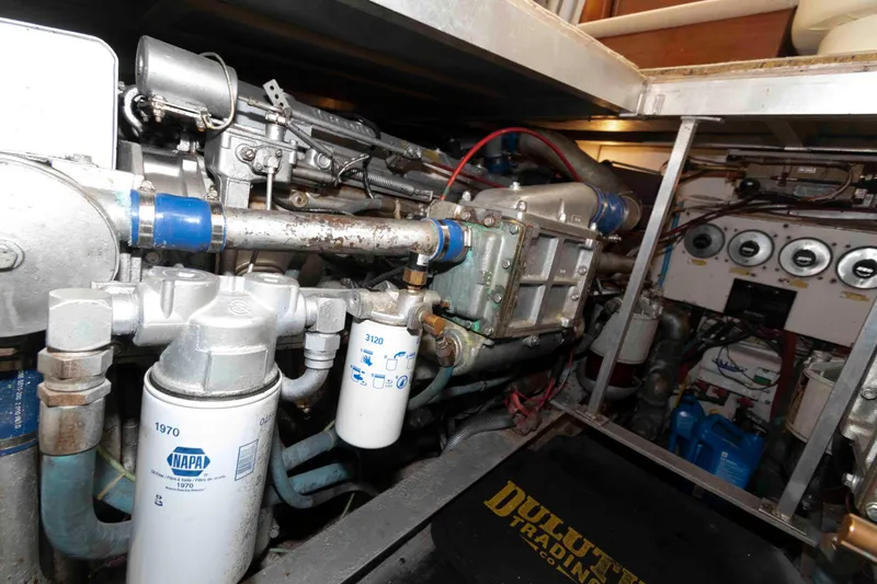 Slide: The Image of Engine room of a 1990 Viking 50 Motor Yacht with visible filters and machinery. - 35