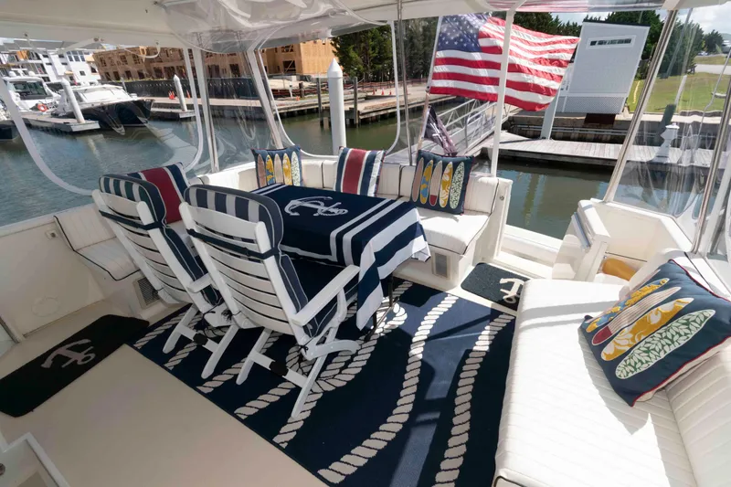 Slide: The Image of Luxurious 1990 Viking 50 Motor Yacht deck with nautical-themed decor and American flag. - 4