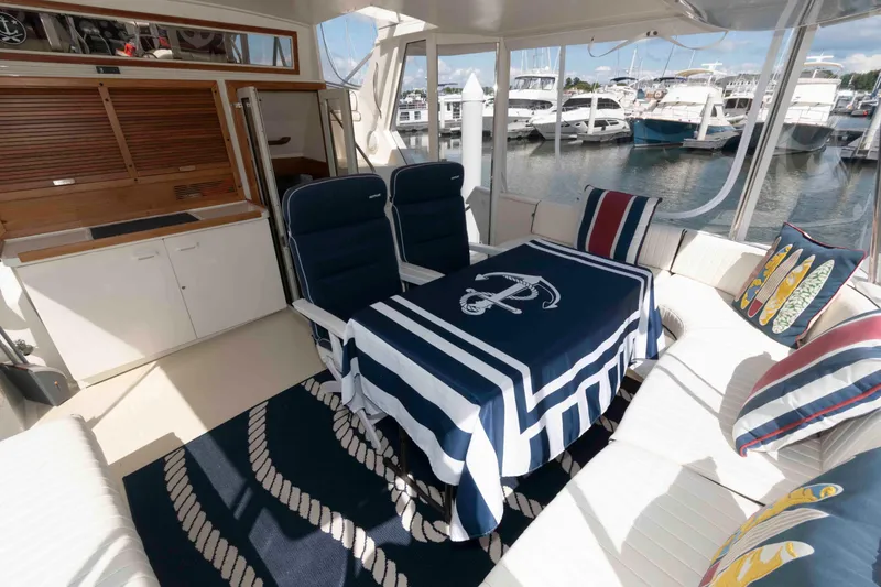 Slide: The Image of Interior of 1990 Viking 50 Motor Yacht with nautical-themed decor and marina view. - 5