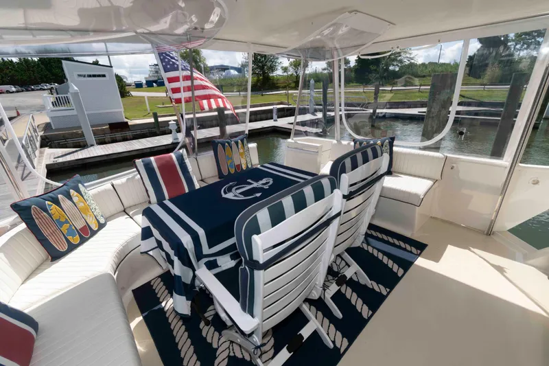 Slide: The Image of 1990 Viking 50 Motor Yacht interior with nautical-themed decor and American flag. - 6