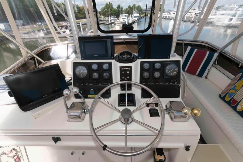 Slide: The Image of Cockpit of 1990 Viking 50 Motor Yacht with navigation equipment and steering wheel. - 9