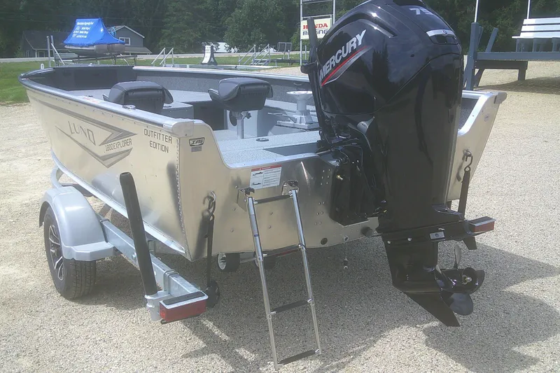 Slide: The Image of 2026 Lund 1800 Explorer Tiller boat with Mercury outboard motor on trailer. - 12