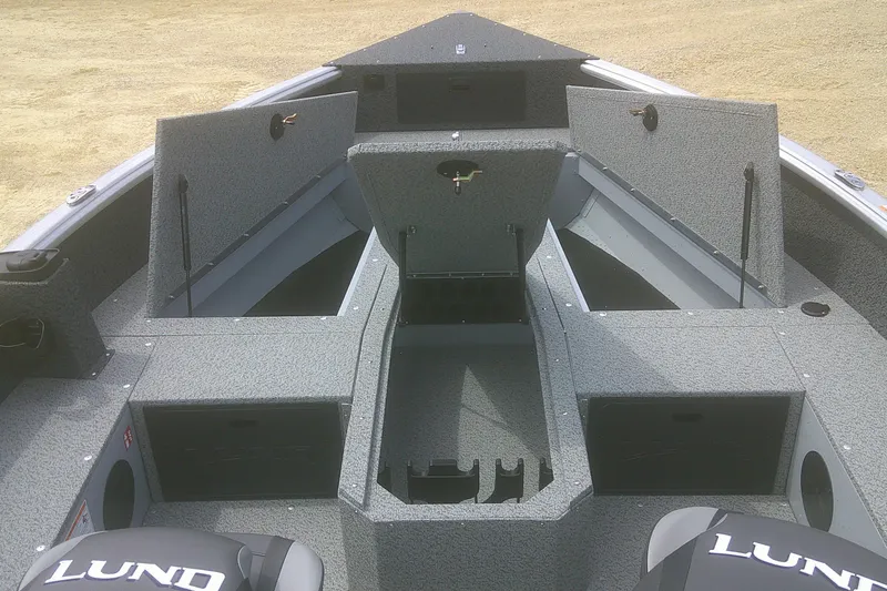 Slide: The Image of 2026 Lund 1800 Explorer Tiller boat interior with open storage compartments. - 4