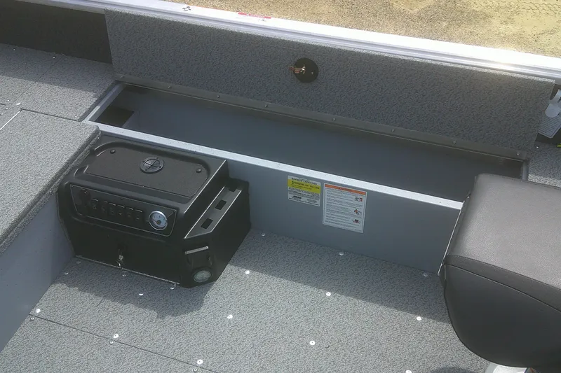 Slide: The Image of 2026 Lund 1800 Explorer Tiller boat interior with storage compartment and control panel. - 7