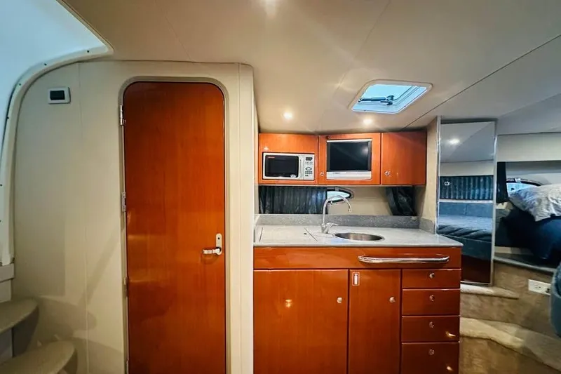 Slide: The Image of Interior of 2006 Formula 31 Performance Cruiser with kitchenette and wooden cabinetry. - 10