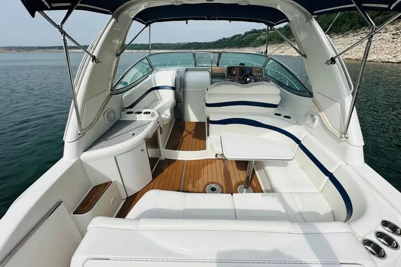 Slide: The Image of 2006 Formula 31 Performance Cruiser interior with white seating and wood accents on a lake. - 5