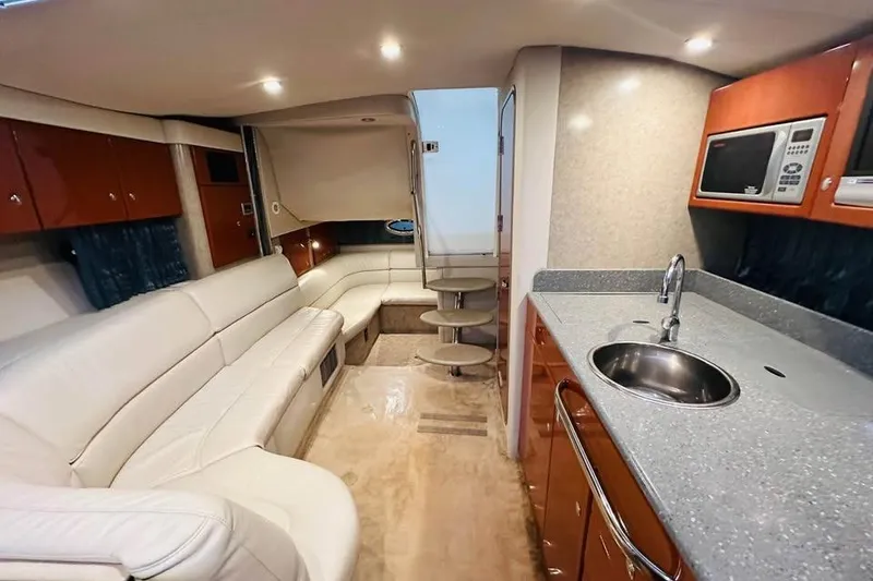 Slide: The Image of 2006 Formula 31 Performance Cruiser interior with kitchen, seating, and modern amenities. - 9