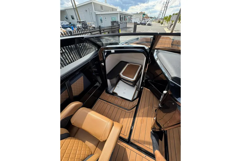 Slide: The Image of 2026 Yamaha Boats 275SD interior with tan leather seating and sleek design. - 14