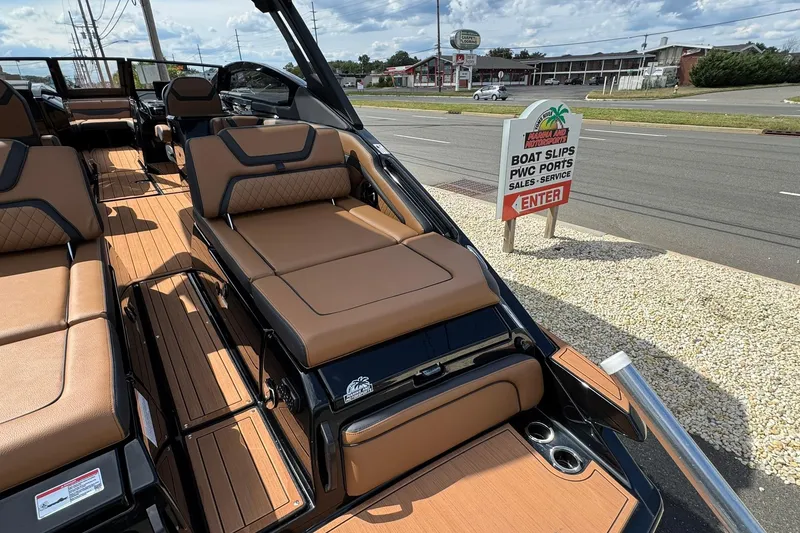 Slide: The Image of Manufacturer Provided Image: 2026 Yamaha Boats 275SD interior with luxurious tan seating and sleek black design. - 18