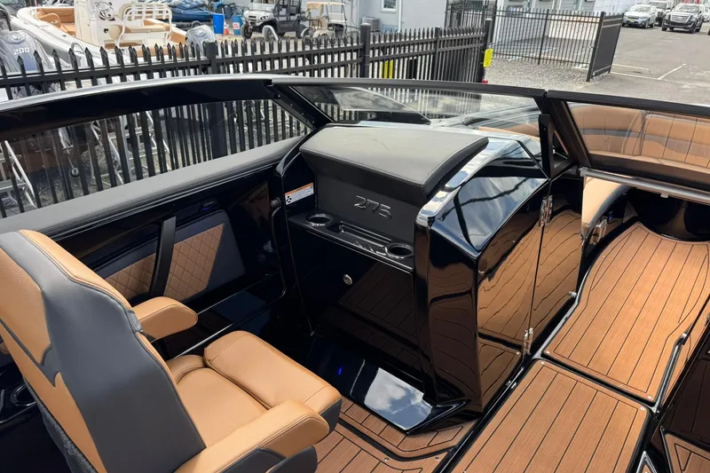 Slide: The Image of 2026 Yamaha Boats 275SD cockpit with modern steering, touchscreen display, and luxurious seating. - 23