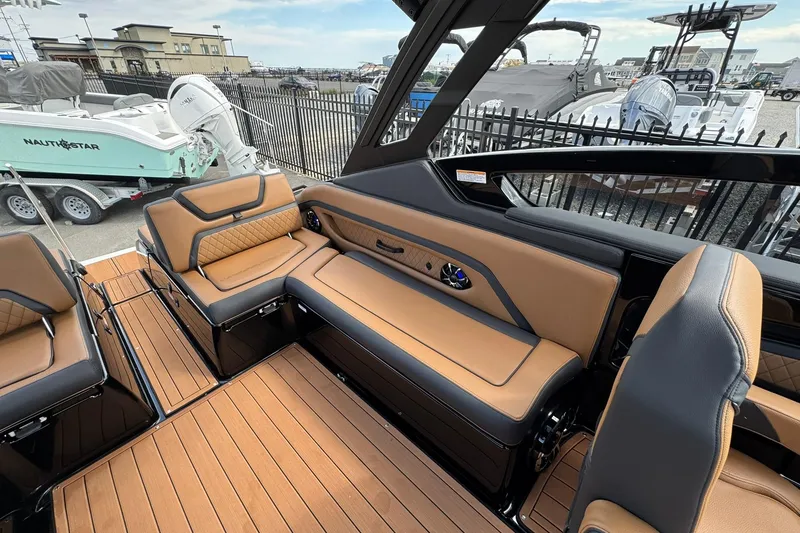 Slide: The Image of 2026 Yamaha Boats 275SD interior with tan seats and sleek black dashboard. - 24