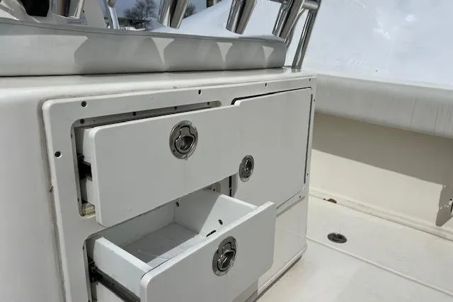 Slide: The Image of 2020 Cobia 237 Center Console boat with open storage compartments. - 13