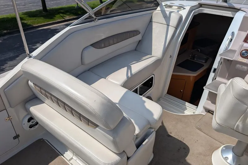 Slide: The Image of 2001 Regal Commodore 2660 boat interior with white seating and cabin entrance. - 11