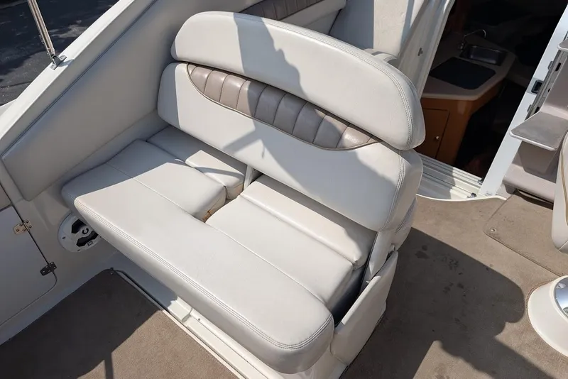 Slide: The Image of 2001 Regal Commodore 2660 boat interior with white cushioned seating. - 12